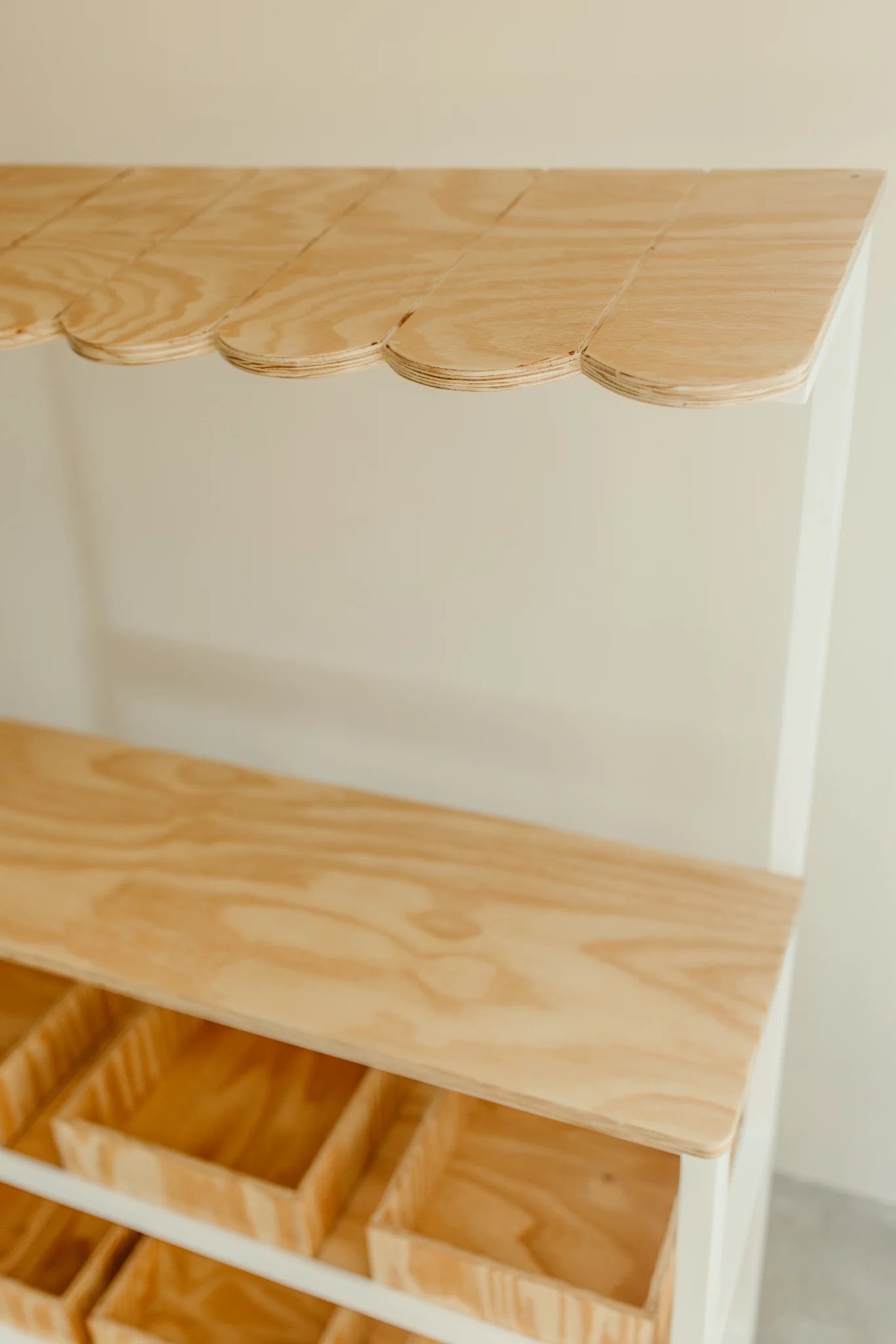 Close-up of scalloped plywood canopy on the kids play shop.