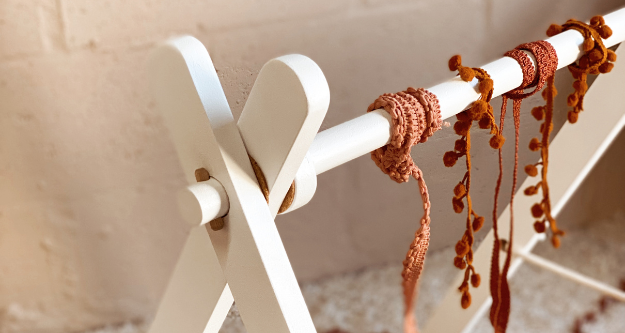 Wooden baby play gym in a white satin painted finish
