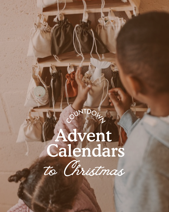 Two young children reaching into fabric bags on a wooden advent calendar, choosing treats as they count down to Christmas. Text on image reads ‘Countdown Advent Calendars to Christmas’.
