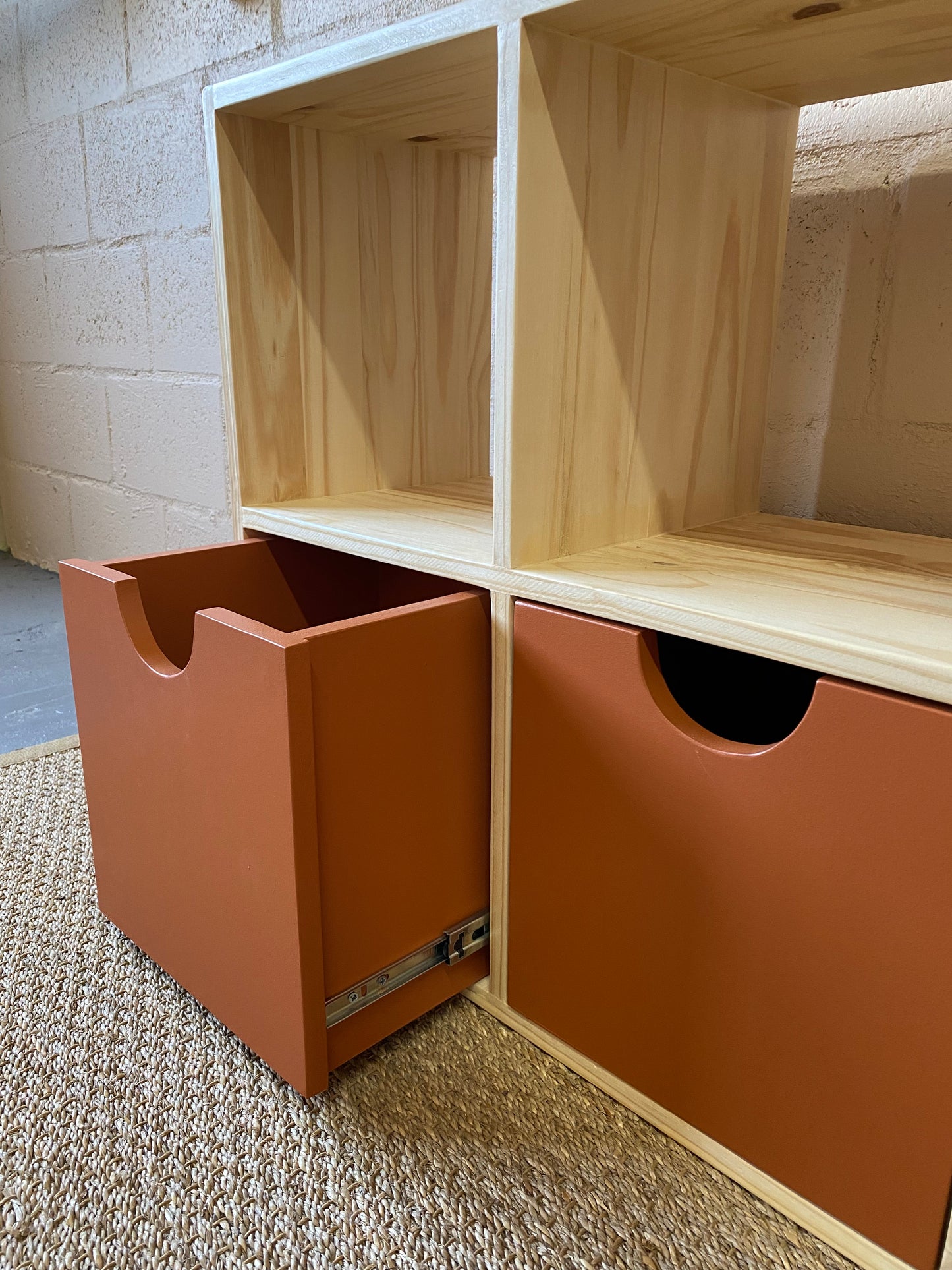 Close-up of Copper storage box mounted on smooth-gliding sliders in handcrafted cube storage unit