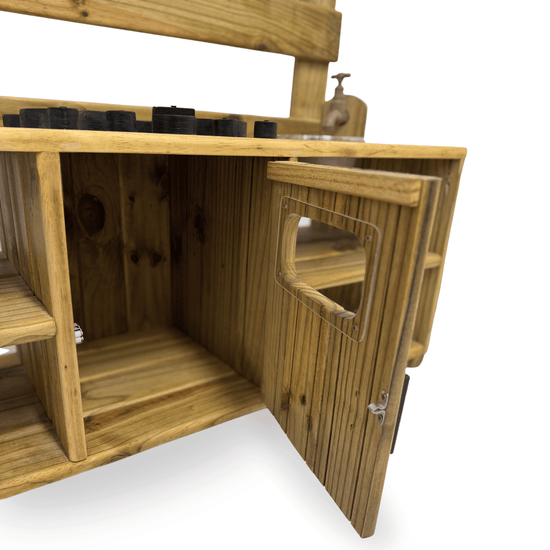 Close-up of the Double Mud Kitchen cupboard door open, showing inner storage space for pots and outdoor play accessories.