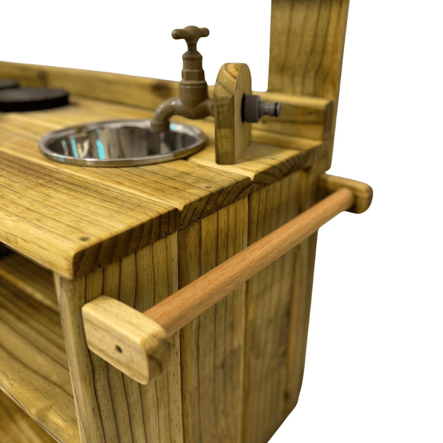 Side view of the Double Mud Kitchen showing solid wood towel or utensil rail and handcrafted brass tap with sink.
