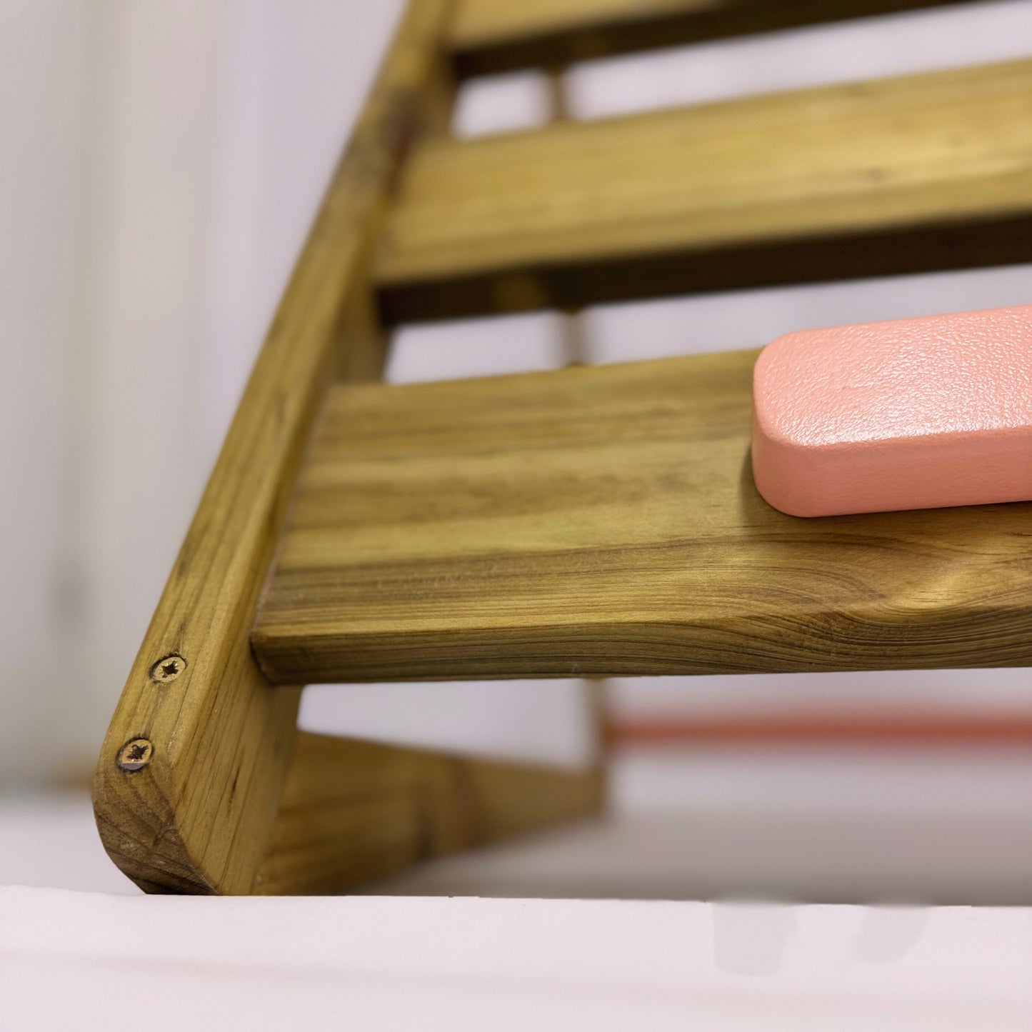 Close up detail of outdoor Pikler triangle showing smooth treated pine finish and rounded edges for safe outdoor play