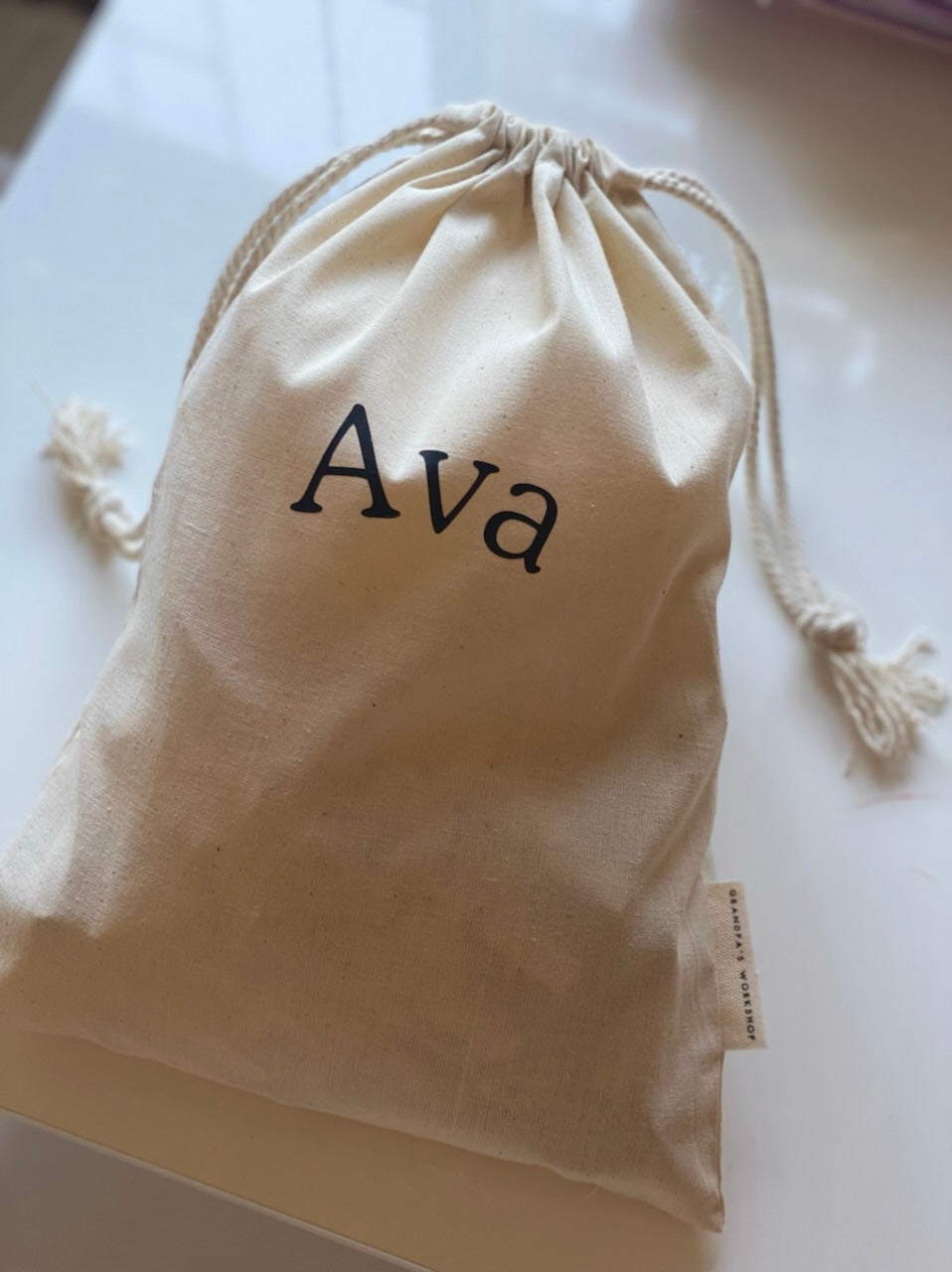 Personalised drawstring bag with name Ava in black print, handcrafted keepsake bag for wooden toy blocks