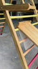 Close-up video of the reversible ramp and slide on the Outdoor Pikler Playground, showing the smooth slide side attaching securely to the treated-timber climbing frame.