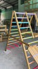 Video showing the Outdoor Pikler Playground fully expanded, featuring rainbow-coloured climbing rungs and a treated-timber frame, designed for outdoor use.