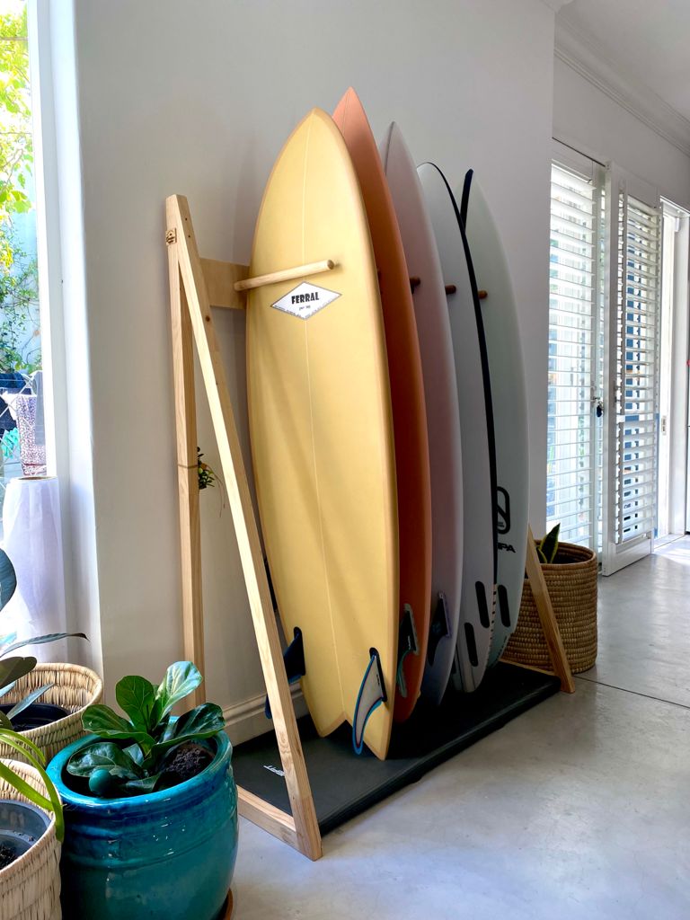 Standard 6 peg Surfboard Stand with foam protective layer on base featuring 4 surfboards on the stand.